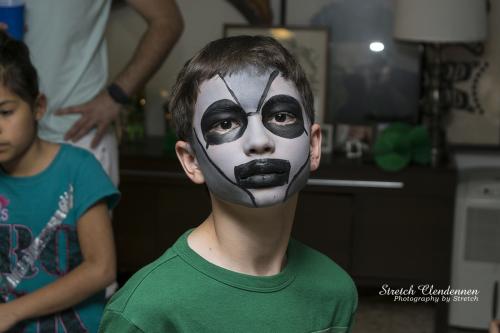 Young boy with robot face paint at birthday party