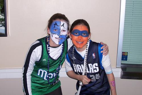 Full face painting on two, young Dallas Mavericks fans at a game