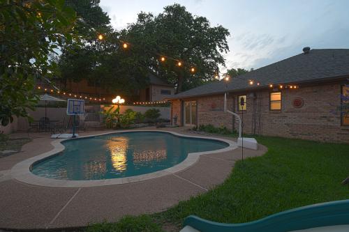 Real Estate Photo - Back yard with a swimming pool at sunset.
